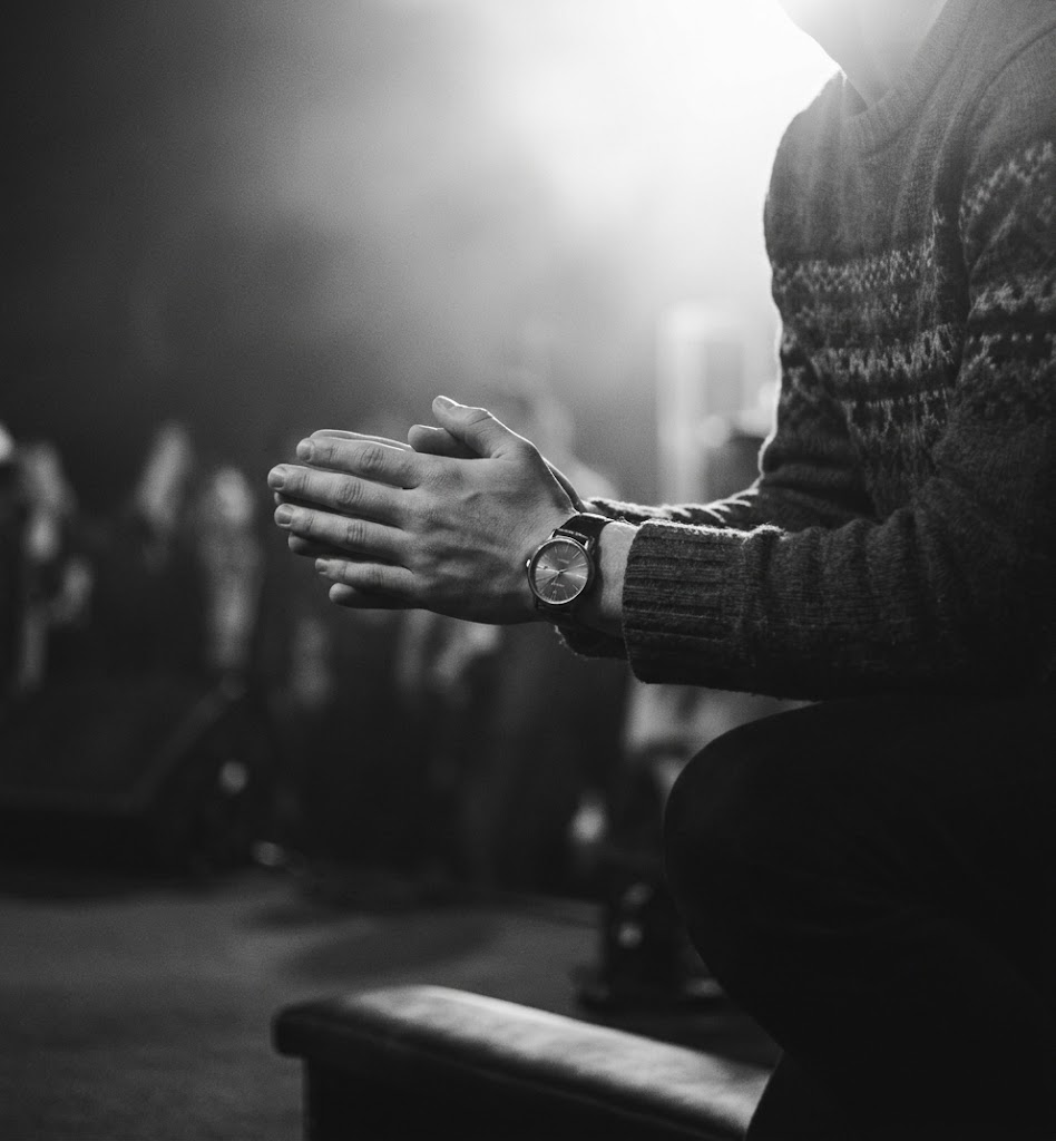 Hands clasped in prayer